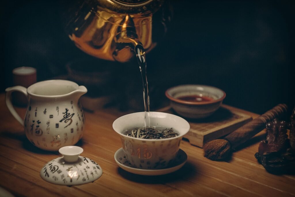 pexels-photo-230477-230477 Artistic depiction of a traditional Chinese tea ceremony with porcelain teaware and hot water pour.